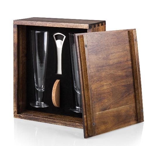 Enhance one’s passion for the brew with the Pilsner Beer Glass Gift Set. This impressive set features a strong acacia wood case with beautiful dovetail joinery. Slide open the removable panel door to reveal deluxe beer service for two: 2 12-oz. fluted beer glasses, 2 real cork beverage coasters and one bottle opener – all showcased and secured within a form-fitting interior. 